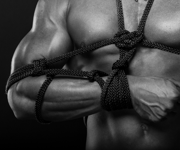 Man tied in bondage - shibari style
