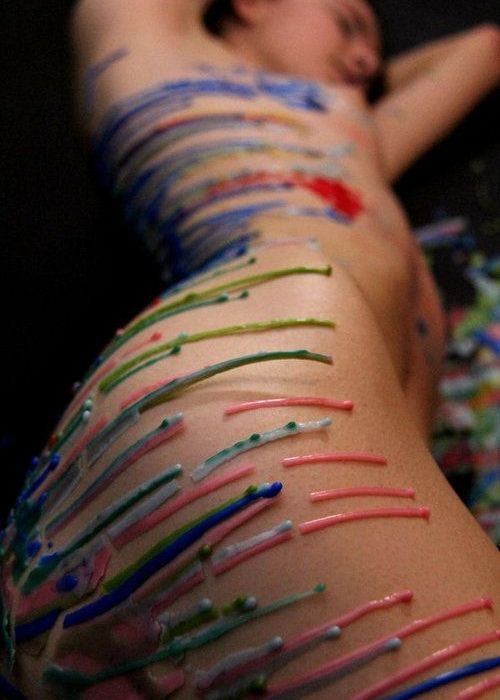 Girl covered in different color wax