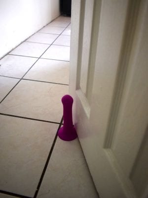 Suction cup dildo as a door holder