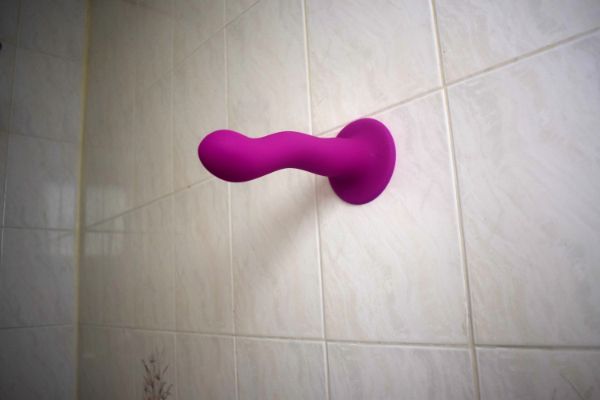 Suction cup dildo on a bathroom tile