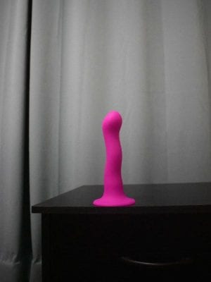 Suction cup dildo on a night stand