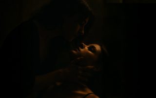 woman holding another woman and looking into her eyes