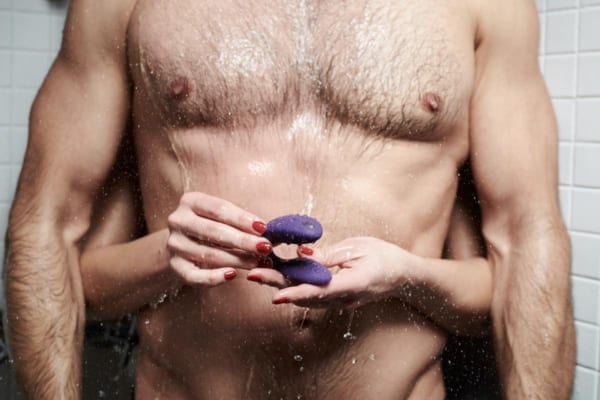 Woman hugging a man and holding a prostate massager