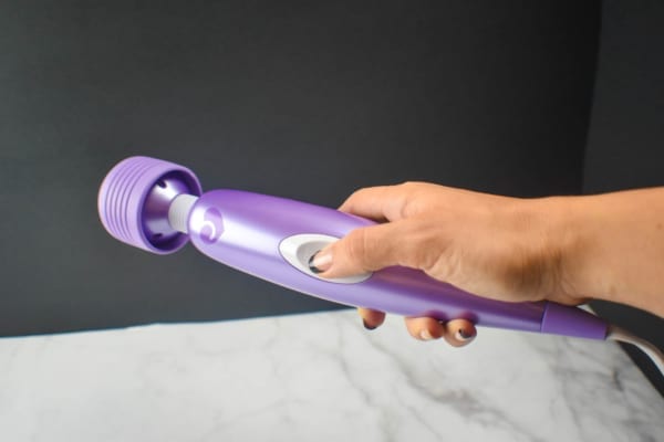 Woman holding wand massager