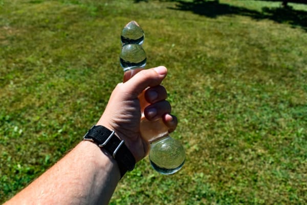 Holding glass dildo