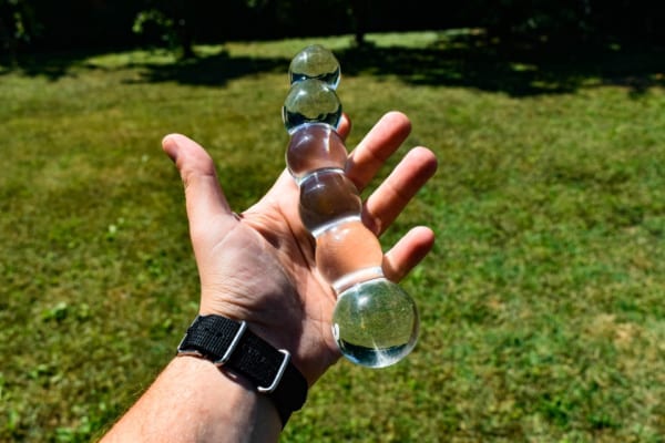 Man holding glass dildo