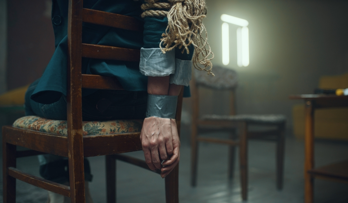 Man tied to a chair during a CNC session