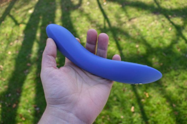 We-Vibe Rave 2 in my hand over a green background