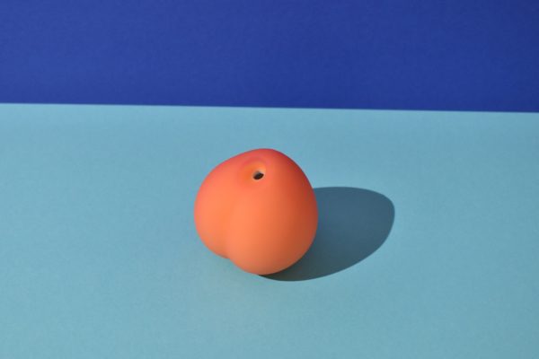 Womanizer Peach on a background