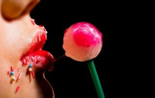 Girl licking a lollipop imitating a deepthroat