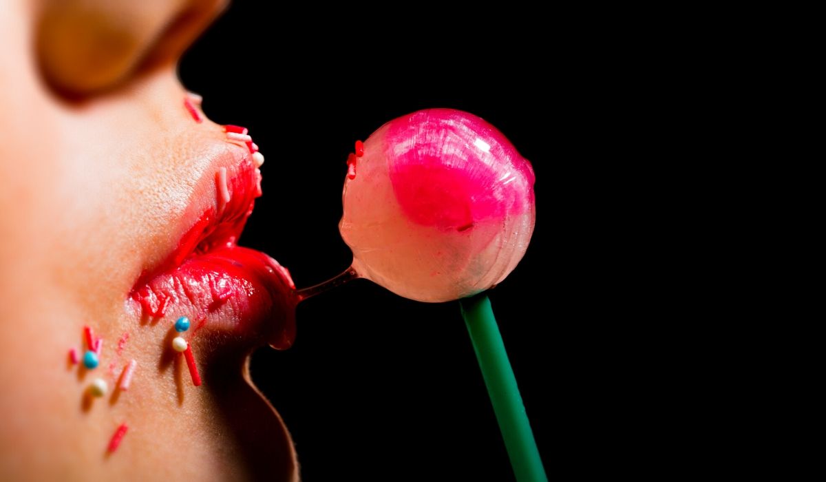 Girl licking a lollipop imitating a deepthroat