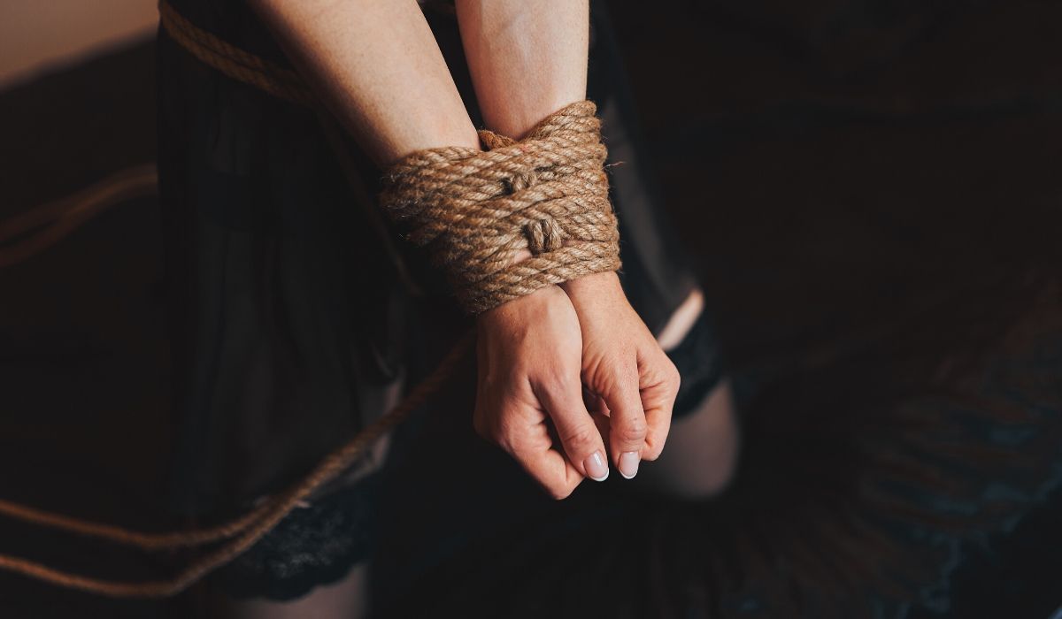 Womans hands tied in bondage