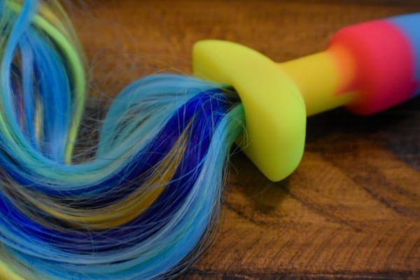 Close up of a rainbow tail attached to a butt plug