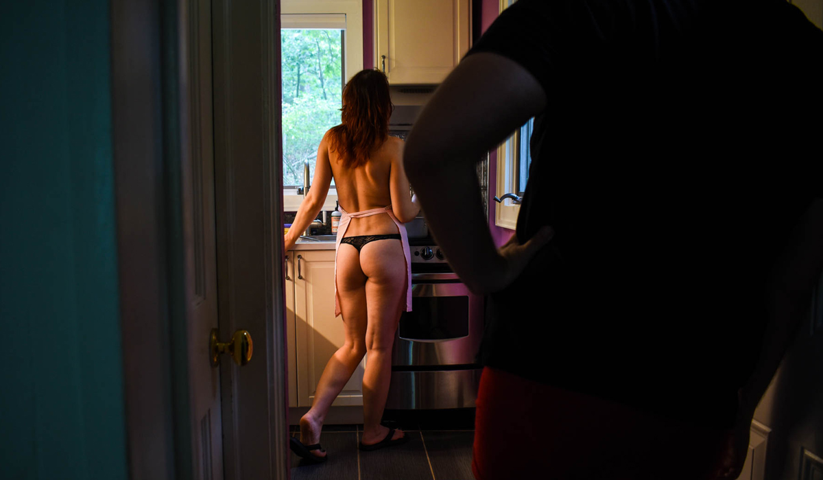 Man watching women in kitchen