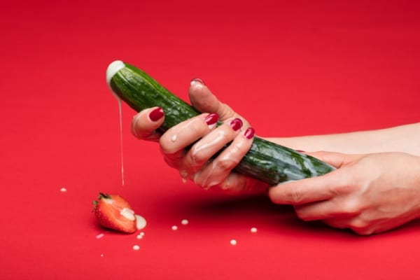 Woman holdin a cucumber