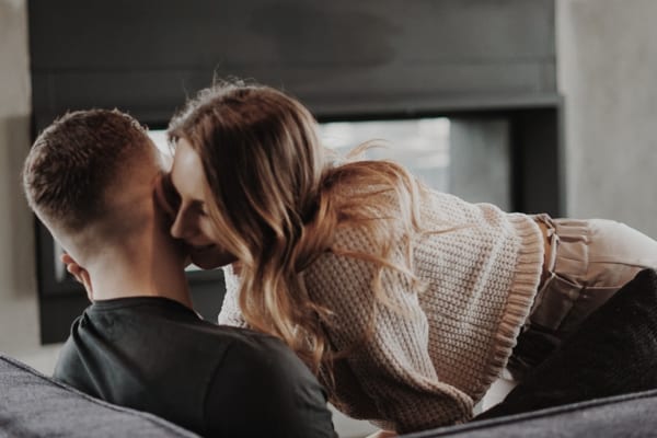 Woman whispering in mens ear