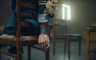 Man tied to a chair during a CNC session