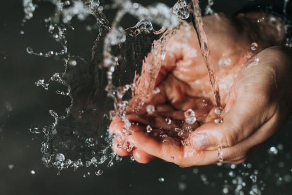 Mans hands and water