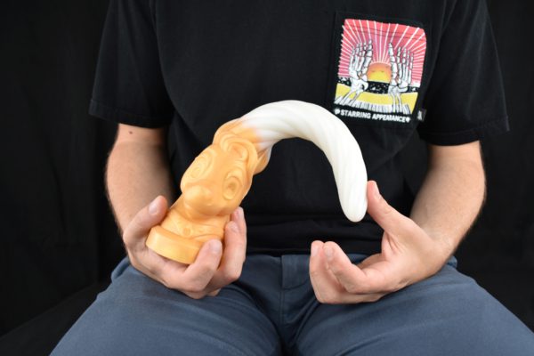 Man bending unicorn dildo