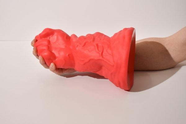 Huge Fist Dildo leaning on a hand