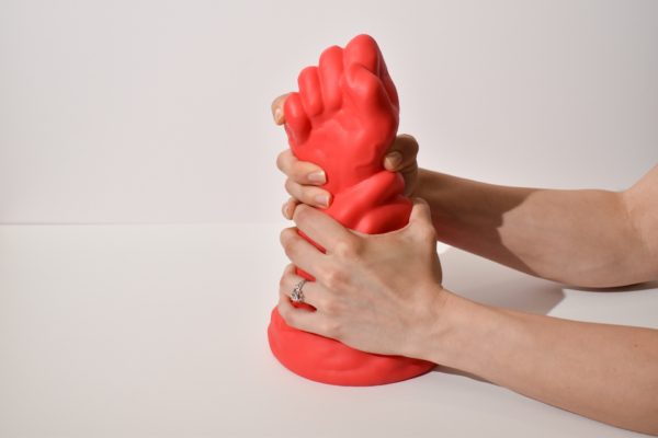 hands holding Huge Fist Dildo